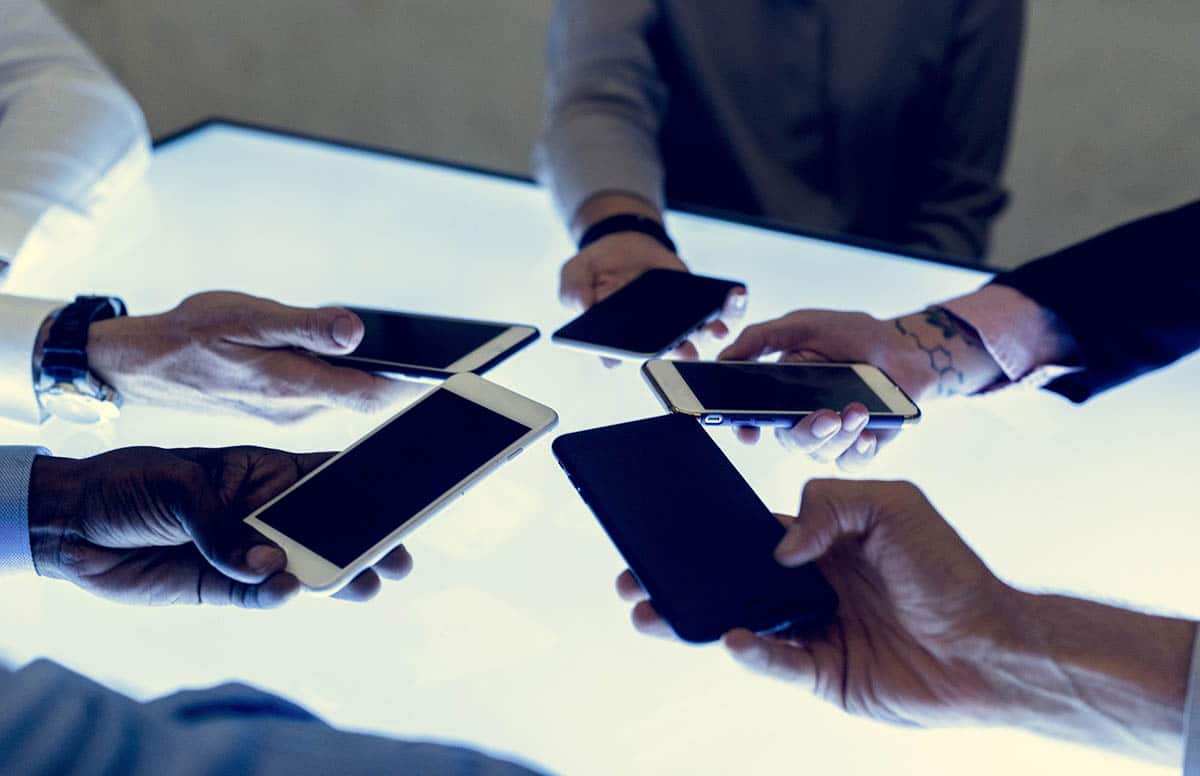 People in a meeting using smartphone