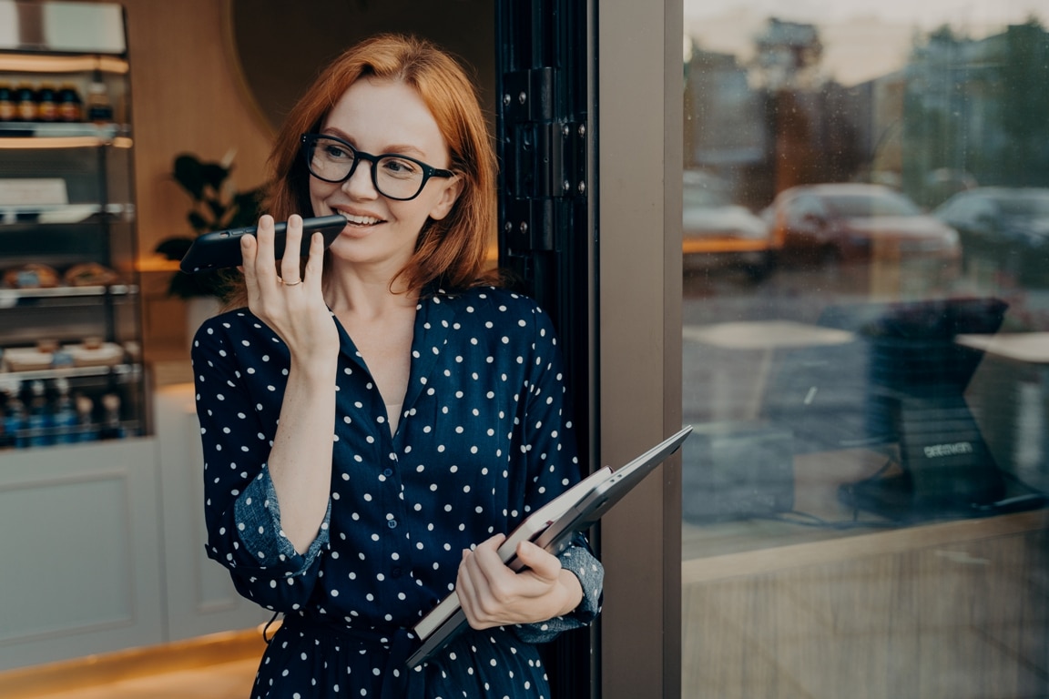 female-freelancer-stands-outdoors-with-mobile-phon-2021