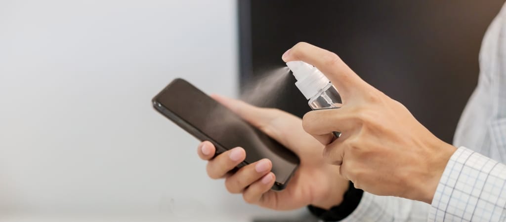 man cleaning smartphone