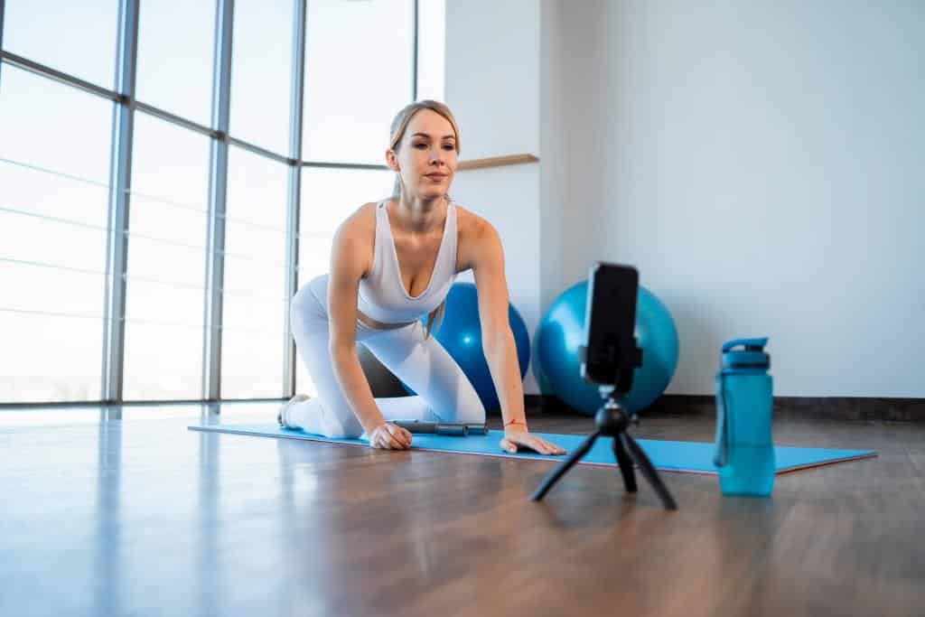 sports girl sits in front of phone camera